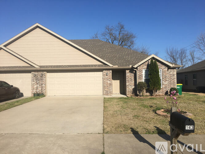 A house with a driveway and a mailbox in front.