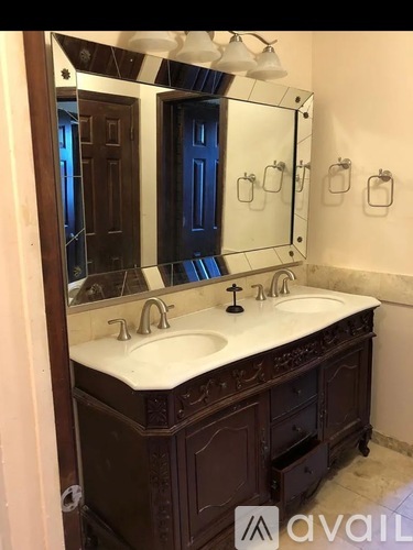 A bathroom with a vanity and a mirror.