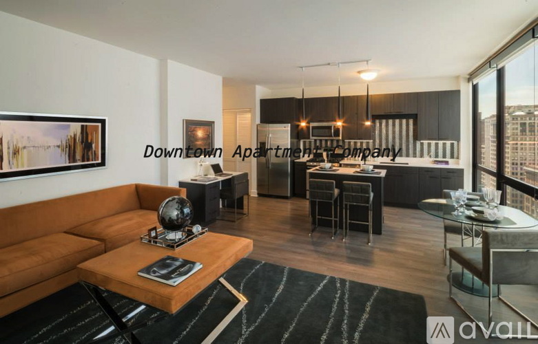 A modern living room with a large window overlooking the city.