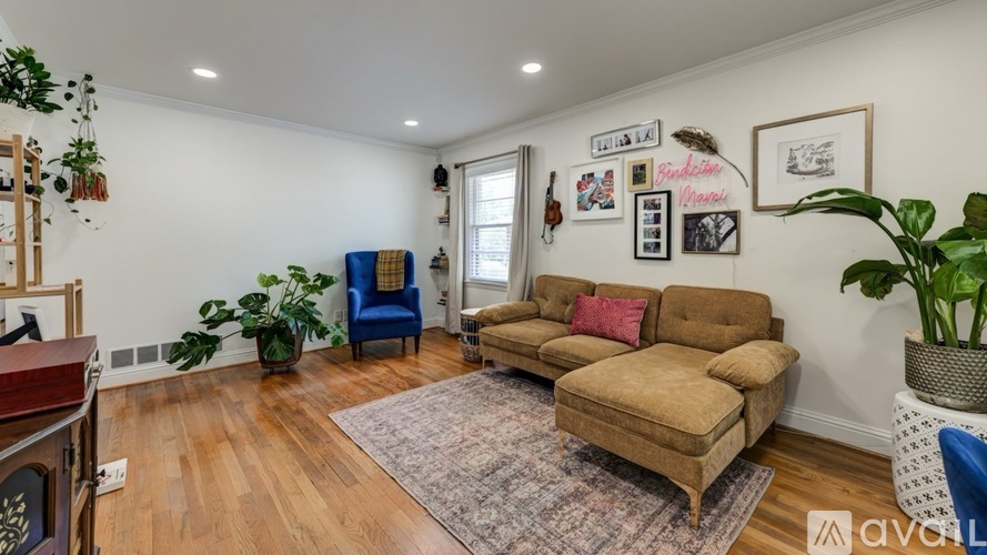 A living room with a brown couch and a blue chair.