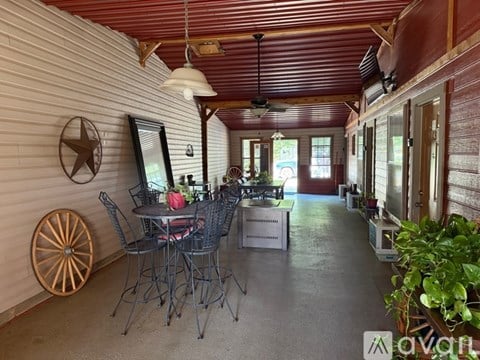 A patio with a table and chairs is shown.