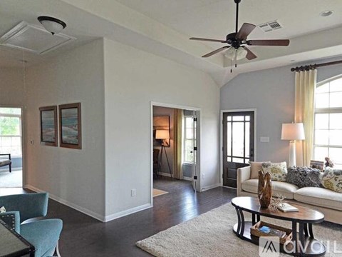 A living room with a white couch and a coffee table.