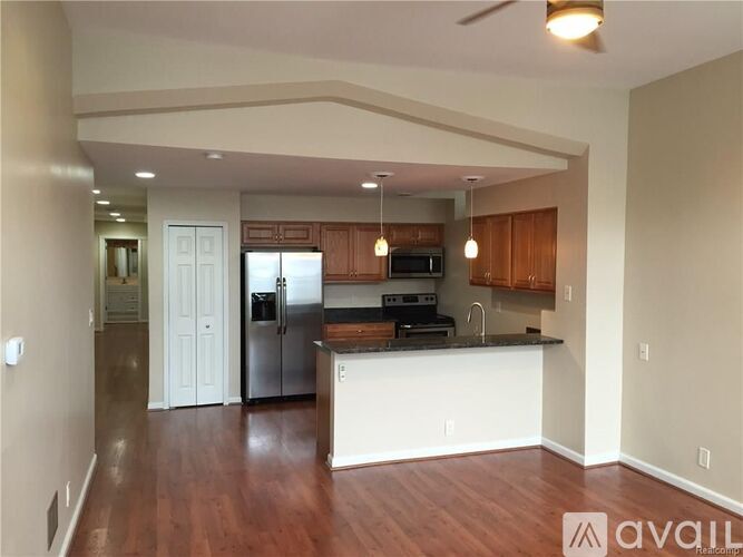 A kitchen with wooden floors and a white island.