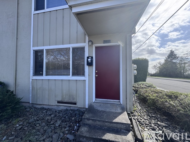 A house with a red door and a small window is shown.