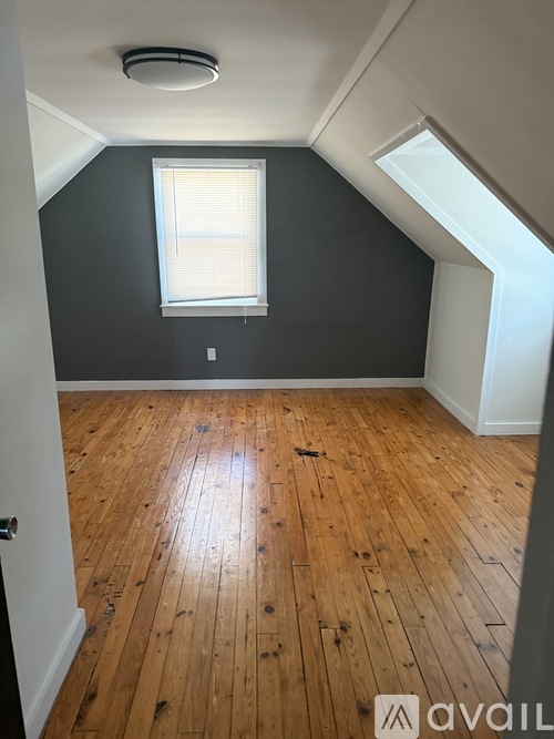 A room with wooden floors and a window.