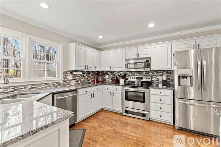 A kitchen with white cabinets and stainless steel appliances.