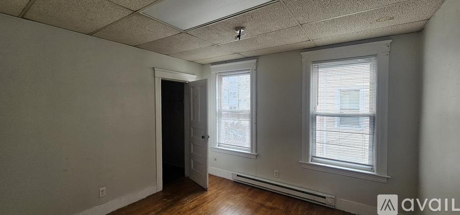 A room with a window and a door.