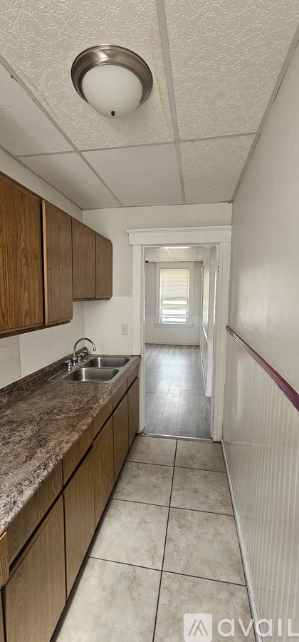 A kitchen with wooden cabinets and a granite countertop.