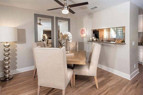A dining room with a table and chairs