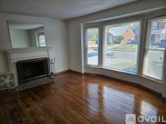 A living room with a fireplace and a view of the outside.