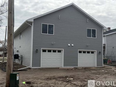A two-car garage with a grey siding exterior.