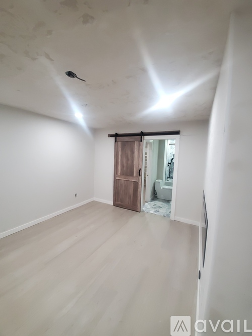 A room with a sliding door leading to a bathroom.