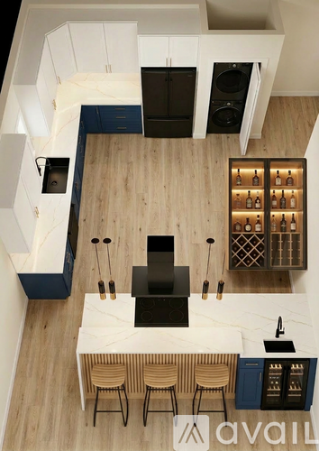 A kitchen with a white counter top and wooden floors.