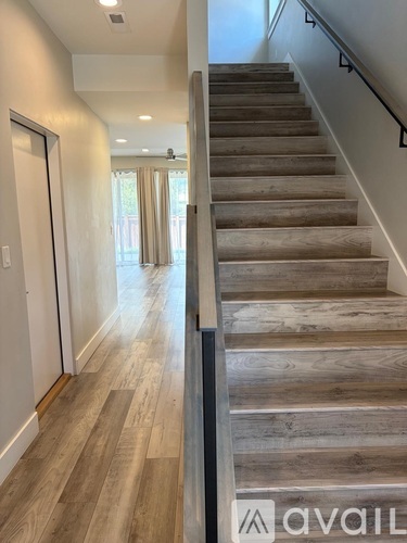 A staircase with wooden steps and a metal railing.