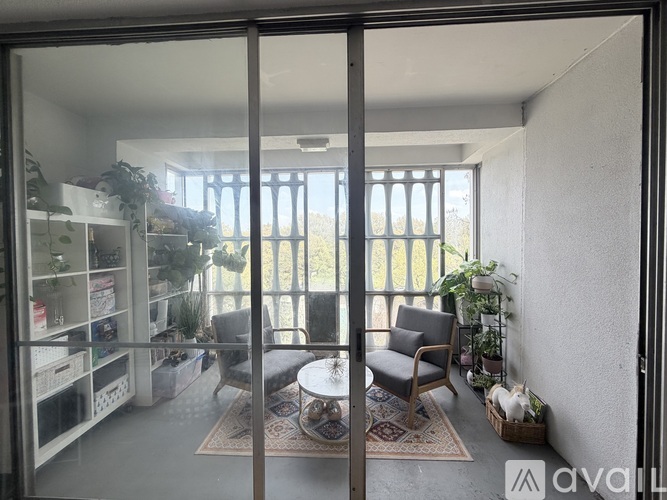 A living room with a glass door leading to a balcony.