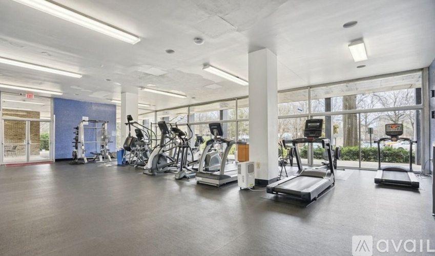 A gym with treadmills, exercise bikes, and other equipment.