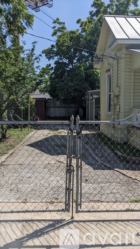 A white house with a gate in front of it.