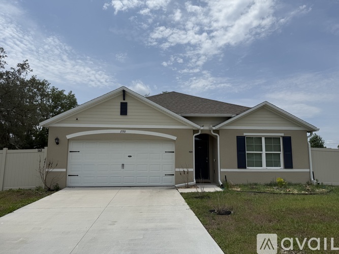 A two-story house with a garage is for sale.
