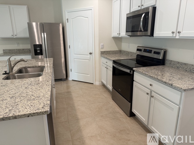 A kitchen with granite countertops and stainless steel appliances.