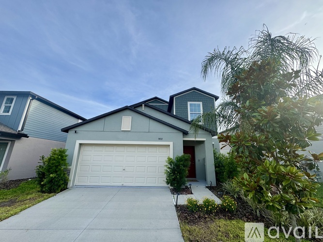 A house with a garage is for sale.