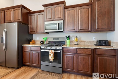 A kitchen with wooden cabinets and a black stove top oven.