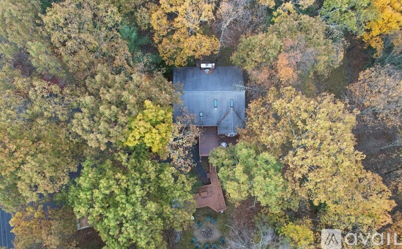 A house surrounded by trees in autumn.