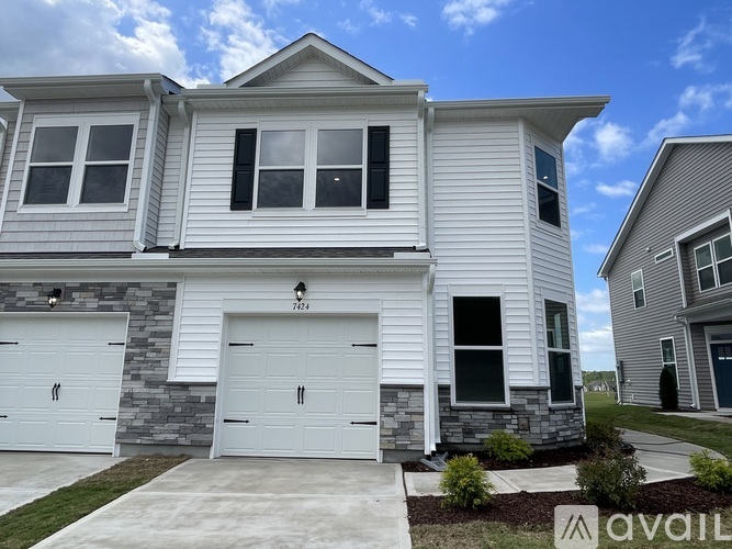 A two-story house with a garage is for sale.