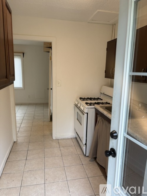 A kitchen with a stove and a refrigerator.