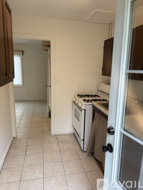A kitchen with a stove and a refrigerator.