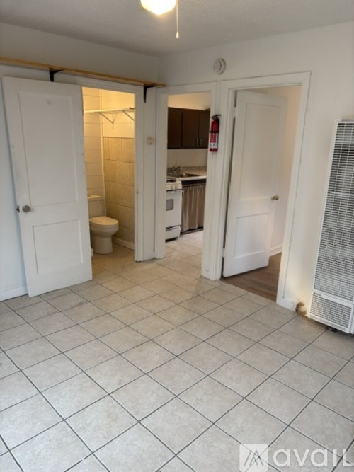 A room with a tile floor and a white door.
