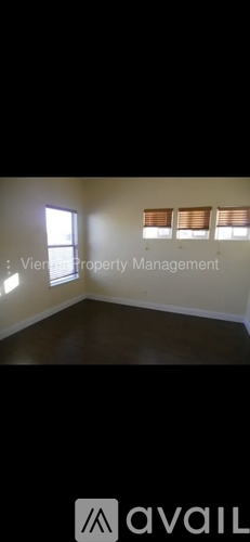 A room with a window and blinds, managed by Viej Property Management.