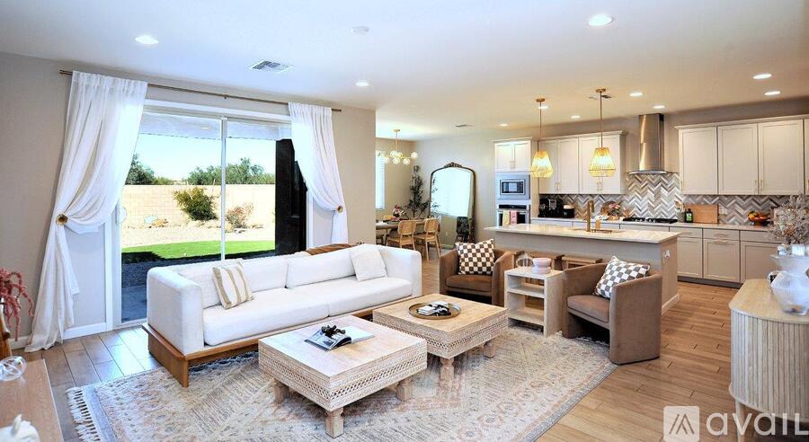 A well-lit living room with a white sofa and a coffee table in the center.