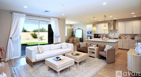 A well-lit living room with a white sofa and a coffee table in the center.