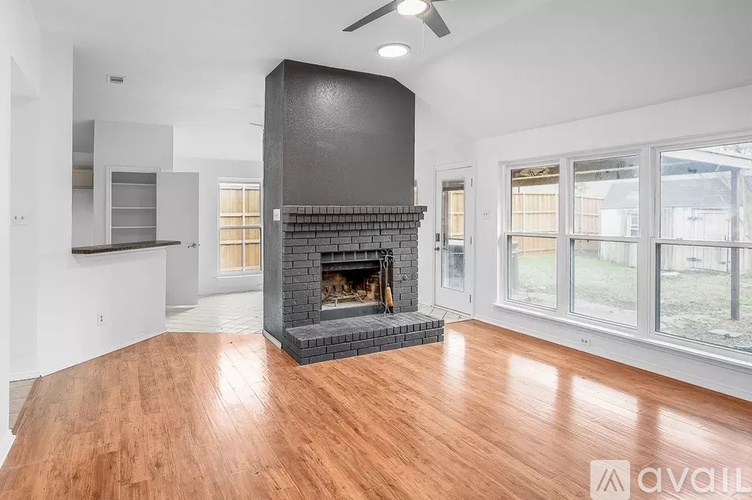 A modern living room with a fireplace and wooden floors.