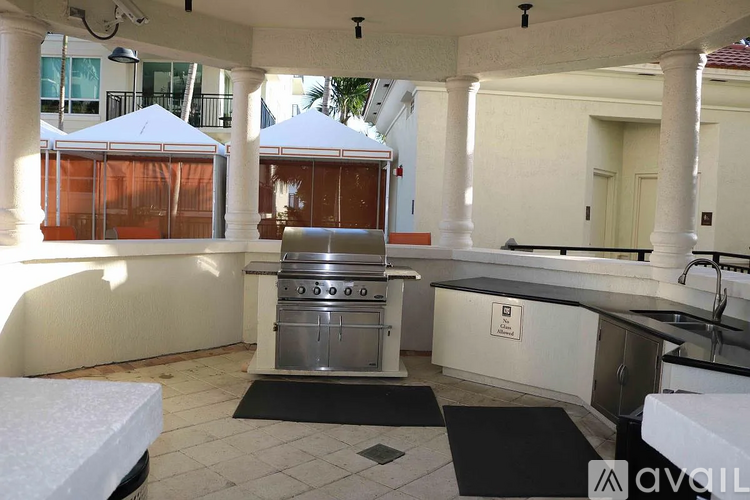 A kitchen area with a sink, stove, and oven.
