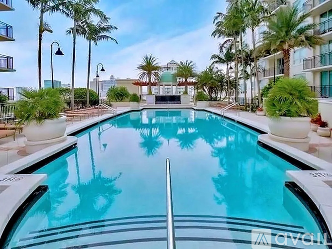 A swimming pool with a metal ladder in the middle of it.