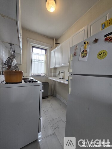 A kitchen with a white fridge and a white stove.