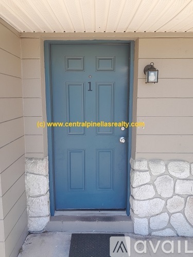 A blue door with a stone pillar on each side.