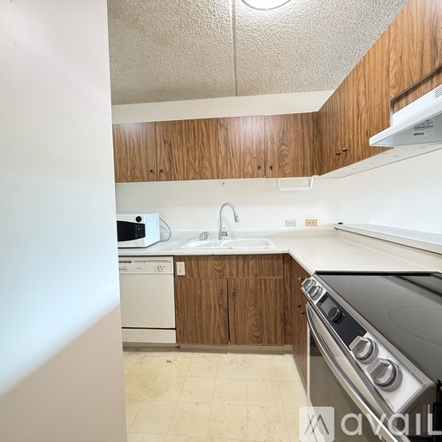 A kitchen with a white oven and wooden cabinets.