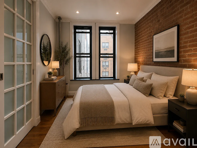 A bedroom with a large bed, a window with black frames, and a wooden headboard.