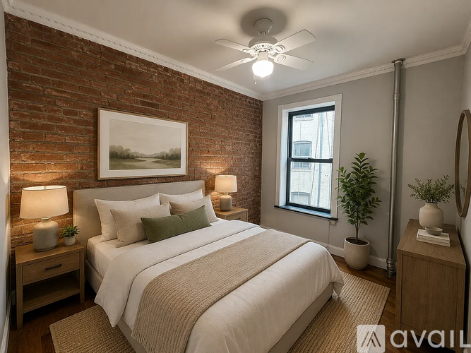 A bedroom with a brick wall and a large bed.