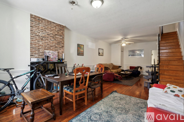 A living room with a brick wall and a bicycle.