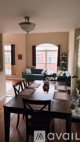 A dining room with a table set for six.
