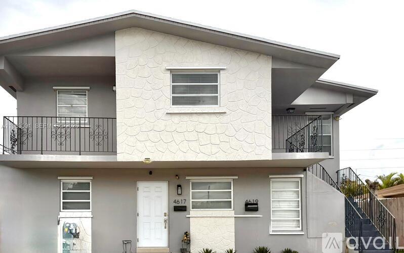 A two-story house with a balcony on the second floor.