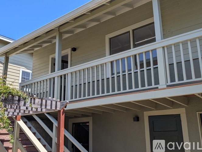 A house with a balcony and a door with a sign that says "available".