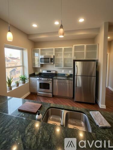 A kitchen with granite countertops and stainless steel appliances.