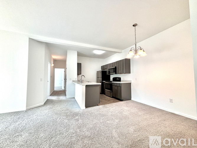A well-lit, spacious kitchen area with a bar counter and a dining table.