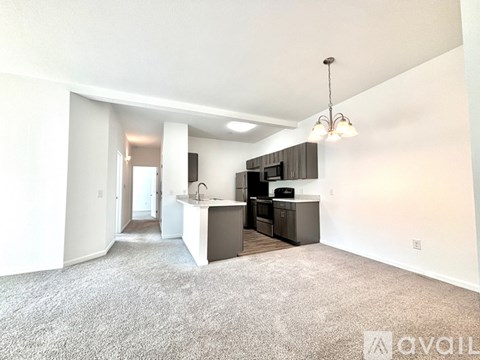 A well-lit, spacious kitchen area with a bar counter and a dining table.