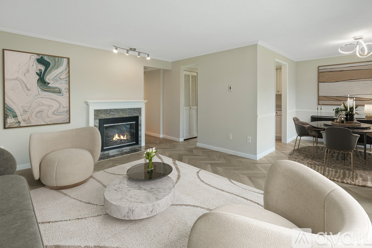 A living room with a fireplace and a painting on the wall.