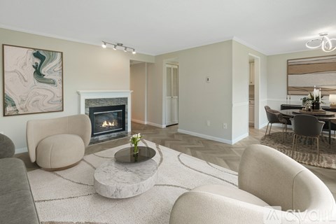 A living room with a fireplace and a painting on the wall.